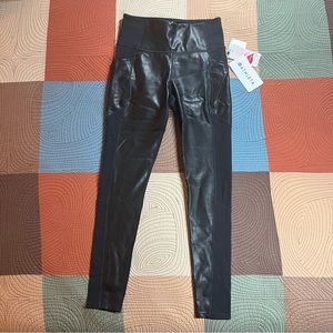 Athleta leggings black, with leather like front, side pockets. Size small.